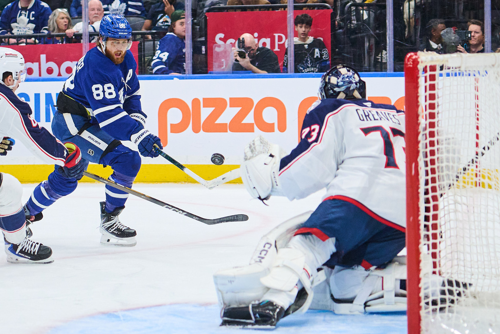 Toronto Maple Leafs' William Nylander (88) shoots against Columbus Blue Jackets goaltender Jet Greaves, right, during second-period NHL hockey game action in Toronto, Thursday, Nov. 20, 2025. (Sammy Kogan/The Canadian Press via AP)