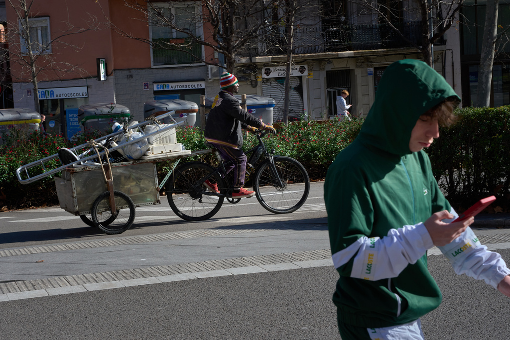 Mamadou, from Senegal, transports scrap metal and discarded electrical appliances on his bicycle after salvaging them from trash containers, as he heads to sell them by weight in Barcelona, Spain, Friday, Jan. 30, 2026. (AP Photo/Emilio Morenatti)