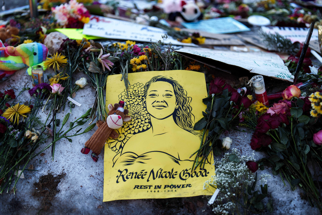 An image depicting Renee Good, who was fatally shot by an ICE officer last week, adorns a makeshift memorial for her in Minneapolis, Wednesday, Jan. 14, 2026. (AP Photo/Adam Gray)