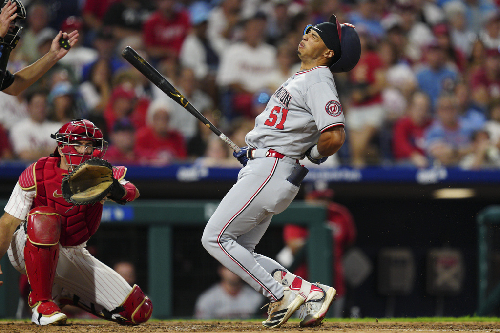 Washington Nationals' Daylen Lile is hit by a pitch from Philadelphia Phillies pitcher Matt Strahm during the eighth inning of a baseball game, Saturday, Aug. 23, 2025, in Philadelphia. (AP Photo/Derik Hamilton)