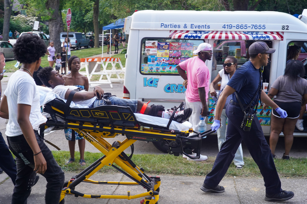 Paramedics treat a person after multiple people were shot at a community festival Saturday, June 6, 2026, in Toledo, Ohio. (Rich Berry via AP)