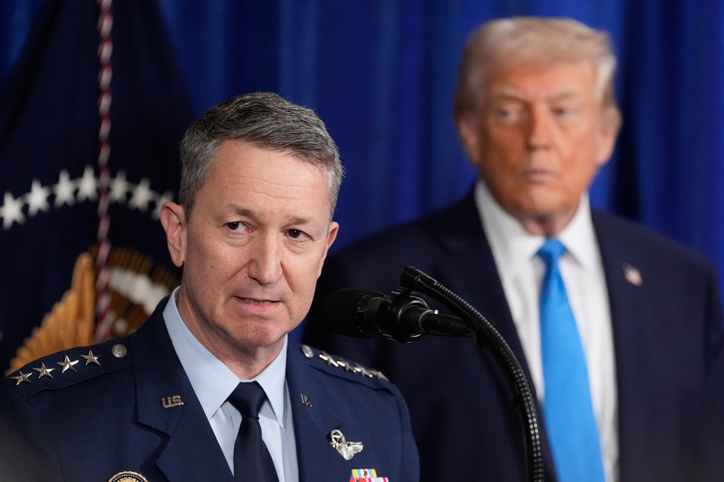 President Donald Trump listens as Chairman of the Joint Chiefs of Staff Gen. Dan Caine speaks at Mar-a-Lago, Saturday, Jan. 3, 2026, in Palm Beach, Fla. (AP Photo/Alex Brandon)