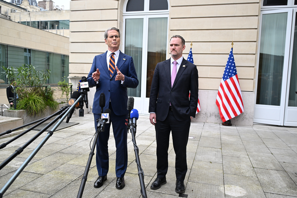 US Treasury Secretary Scott Bessent, left, addresses journalists during a news conference with US Trade Representative Jamieson Greer, right, at the OECD Headquarters, Monday, March 16, 2026, in Paris, France. (AP Photo/Emma Da Silva)