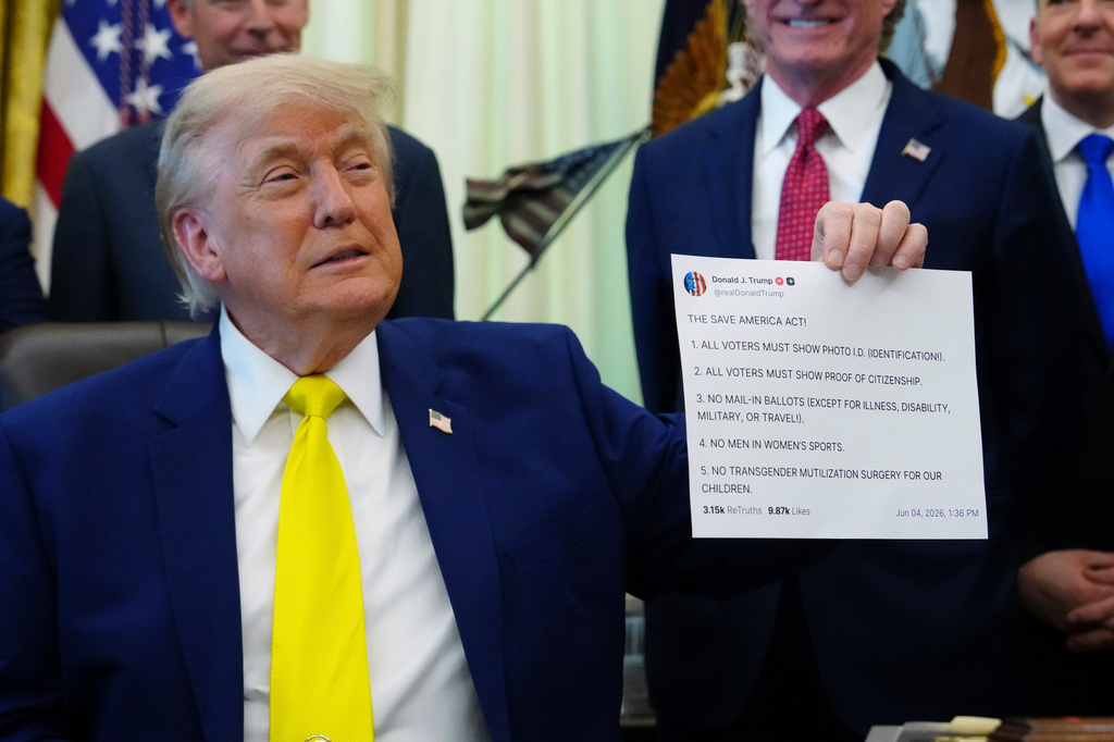 FILE - President Donald Trump holds up an image taken from his Truth Social account at an event about coal, Thursday, June 4, 2026, in the Oval Office of the White House in Washington. (AP Photo/Julia Demaree Nikhinson,File)