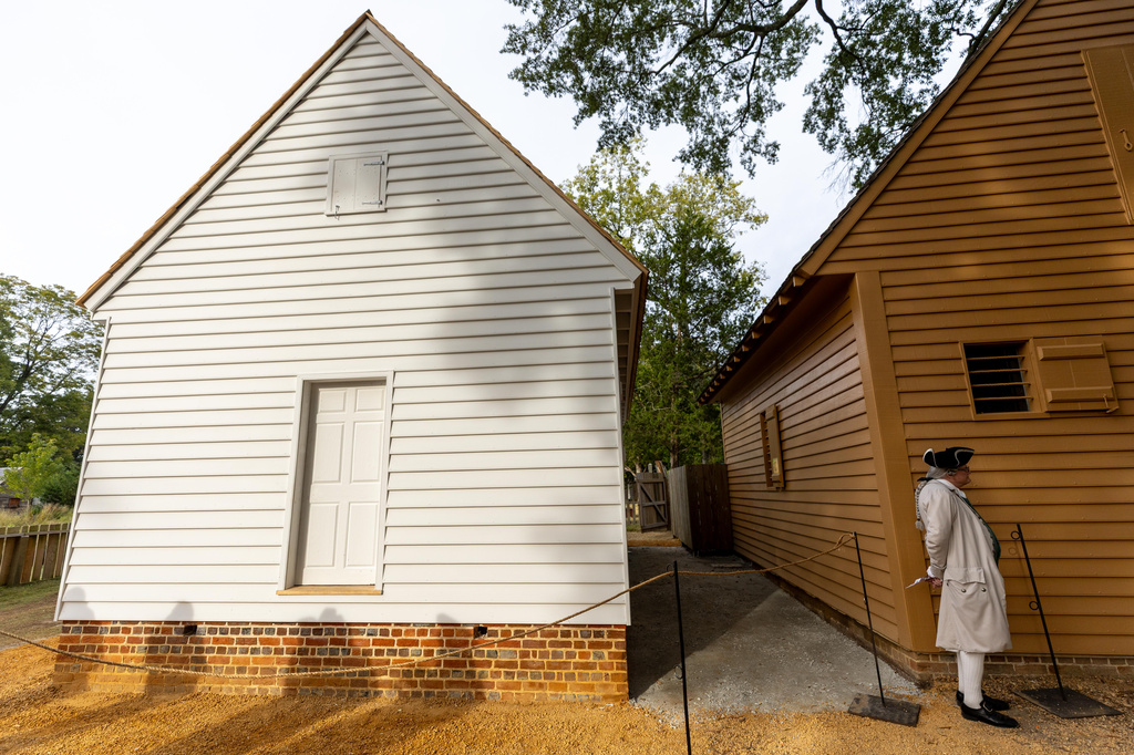 Shadows are cast on the facade of the reconstructed African Baptist Meeting House, now known as the First Baptist Church of Williamsburg, during a rededication ceremony in Williamsburg, Va., Friday, Oct. 9, 2026. (AP Photo/Mike Kropf)