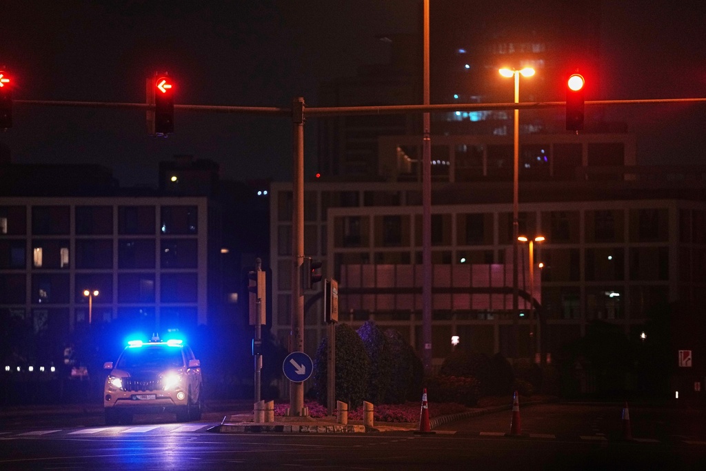 A police car blocks a street leading to the U.S. consulate after an Iranian drone struck a parking lot outside the compound, sparking a small fire in Dubai, United Arab Emirates, early Wednesday, March 4, 2026. (AP Photo/Fatima Shbair)