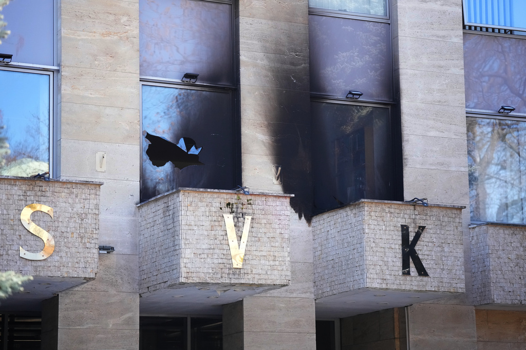 A damaged window and facade is seen after an unknown perpetrator threw several Molotov cocktails at a Russian center in Prague, Czech Republic, Friday, March 27, 2026. (AP Photo/Petr David Josek)