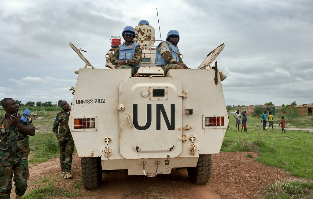 FILE - In this Sunday, June 18, 2017 file photo, peacekeepers from the United Nations Mission in South Sudan (UNMISS) provide security during a visit of UNCHR High Commissioner Filippo Grandi to the U.N. Protection of Civilians camp in Bentiu, South Sudan. (AP Photo/Sam Mednick, File)