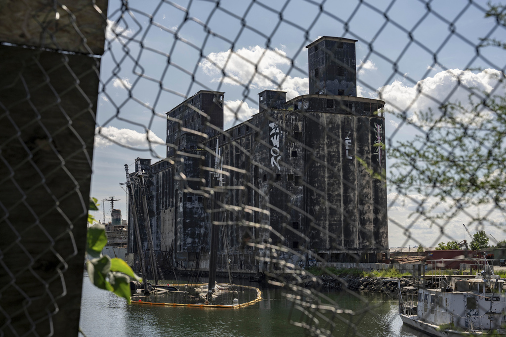 Debris of the Victory Chimes and the Pilot floats next to abandoned Red Hook Grain Terminal in the Henry Street Basin, Wednesday, Aug. 26, 2026, in the Brooklyn borough of New York. (AP Photo/Yuki Iwamura)
