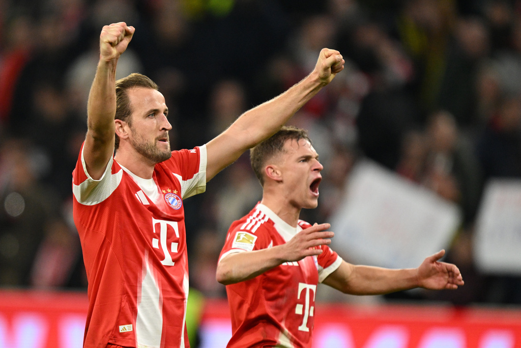 Bayern's Harry Kane, left, and Bayern's Joshua Kimmich celebrate their victory at the Bundesliga soccer match between Bayern Munich and Borussia Dortmund in Munich, Germany, Saturday, Oct. 18, 2025. (AP Photo/Lennart Preiss)