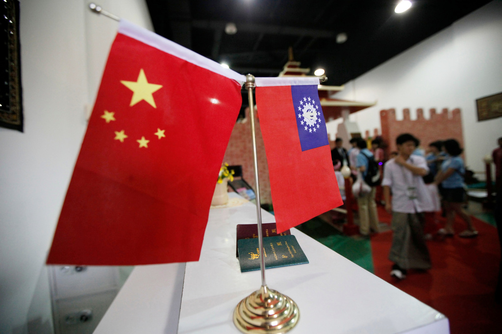 FILE - Flags of China and Myanmar are displayed at the entrance of Myanmar Pavilion prior to Myanmar's top junta leader Gen. Than Shwe to arrive at the Shanghai Expo site in Shanghai Friday, Sept.10, 2010. (AP Photo/Eugene Hoshiko, file)