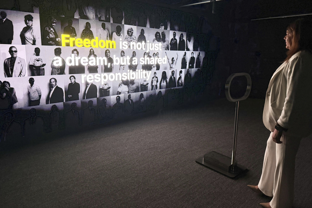 Miami Dade College President Madeline Pumariega explores a museum exhibit honoring Cuban exiles at the Freedom Tower in Miami on Friday, Aug. 8, 2025. (AP Photo/Joshua Goodman)