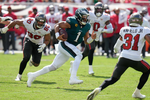 Philadelphia Eagles quarterback Jalen Hurts (1) rushes past Tampa Bay Buccaneers defensive line Logan Hall (90) during the second half of an NFL football game Sunday, Sept. 28, 2025, in Tampa, Fla. (AP Photo/Chris O'Meara) Philadelphia Eagles quarterback Jalen Hurts (1) rushes past Tampa Bay Buccaneers defensive line Logan Hall (90) during the second half of an NFL football game Sunday, Sept. 28, 2025, in Tampa, Fla. (AP Photo/Chris O'Meara)