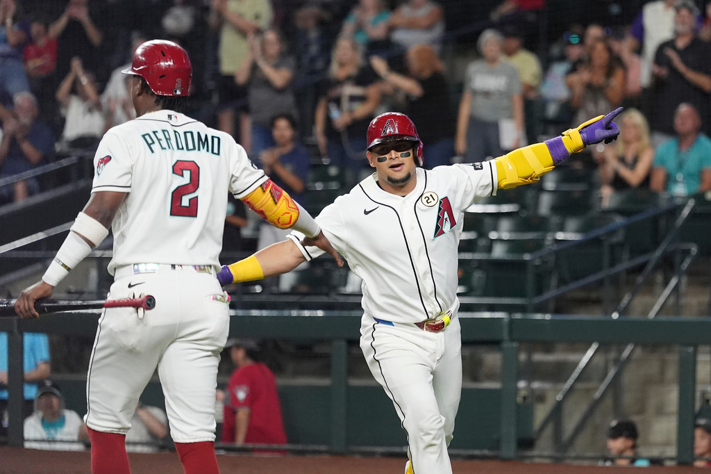 Arizona Diamondbacks' Gabriel Moreno, right, celebrates his home run against the Miami Marlins with Diamondbacks' Geraldo Perdomo (2) during the first inning of a baseball game, Tuesday, Sept. 15, 2026, in Phoenix. (AP Photo/Ross D. Franklin)