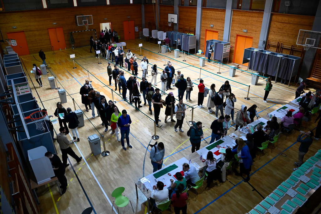 People queue up at a polling station during the Hungarian parliamentary election in Budapest, Hungary, Sunday, April 12, 2026. (AP Photo/Denes Erdos)
