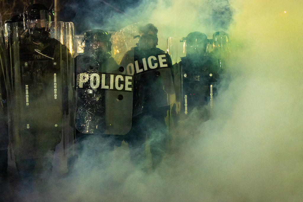 Law Enforcement Officers walk through tear gas chemical irritant during clashes with anti-ICE protesters outside the Delaney Hall detention center on Saturday, May 30, 2026, in Newark, N.J. (AP Photo/Angelina Katsanis)