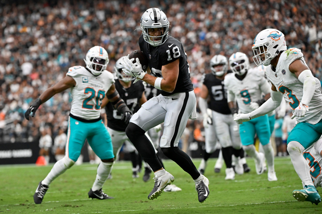 Las Vegas Raiders wide receiver Jack Bech (18) catches a touchdown pass in front of Miami Dolphins cornerback Chris Johnson (3) during the first half of an NFL football game, Sunday, Sept. 13, 2026, in Las Vegas. (AP Photo/David Becker)