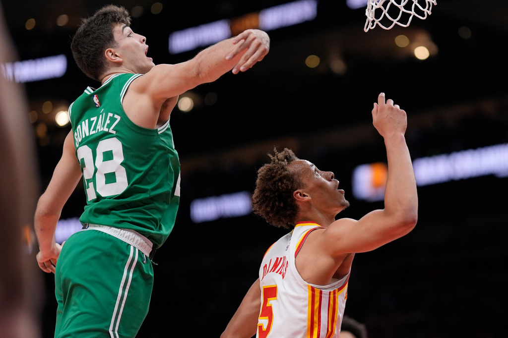 Atlanta Hawks guard Dyson Daniels (5) shoots against Boston Celtics guard Hugo Gonzalez (28) in the first half of an NBA basketball game, Monday, March 30, 2026, in Atlanta. (AP Photo/Mike Stewart)