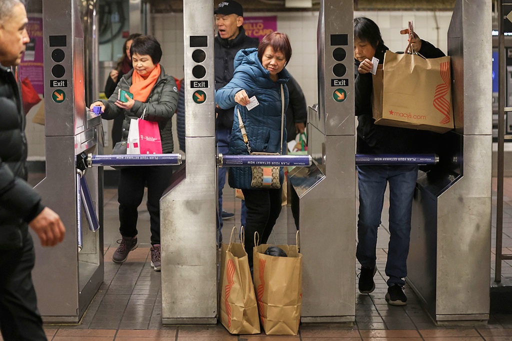 FILE - Shoppers swipe their MetroCards as they enter the subway turnstiles, Nov. 29, 2024, in New York. (AP Photo/Heather Khalifa, File)