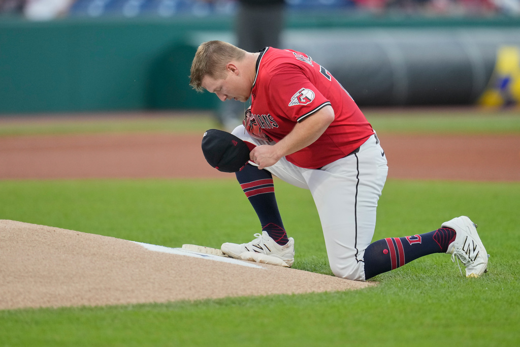 Cleveland Guardians starting pitcher Parker Messick kneels behind the pitcher's mound before a baseball game against the Detroit Tigers in Cleveland, Thursday, Sept. 25, 2025. (AP Photo/Sue Ogrocki)