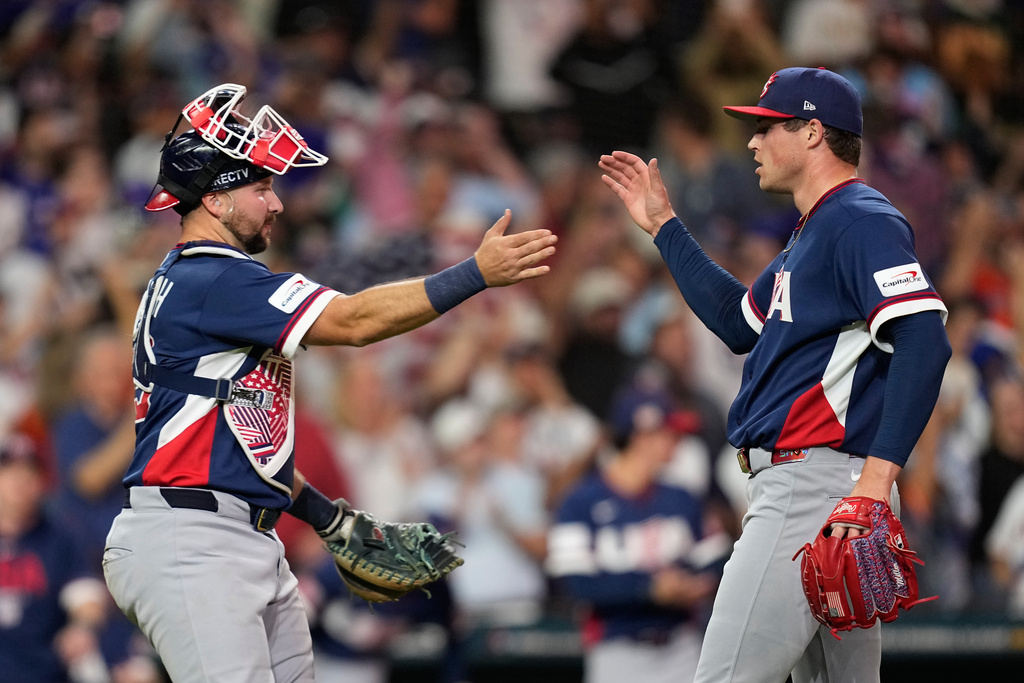 United States catcher Cal Raleigh, left, and pitcher Mason Miller, right, celebrate after their win over Canada in a World Baseball Classic quarterfinal game, Friday, March 13, 2026, in Houston. (AP Photo/David J. Phillip)