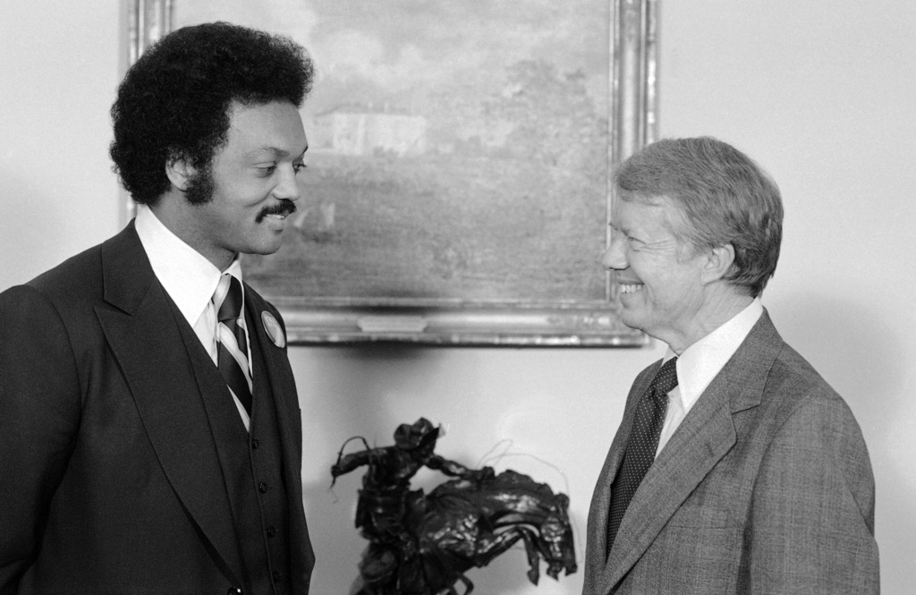 FILE - President Jimmy Carter speaks with the Rev. Jesse Jackson at the White House in Washington, April 4, 1979. (AP Photo/Bob Daugherty, File)