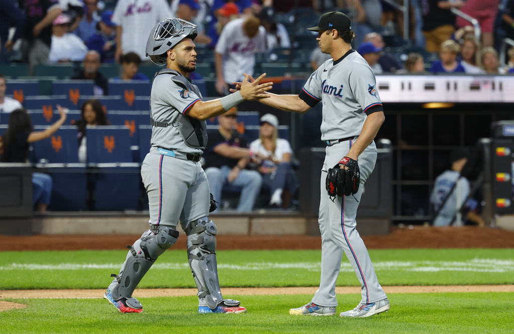 Miami Marlins catcher Agustín Ramírez (50) and pitcher Tyler Phillips celebrate after defeating the New York Mets, Saturday, Aug. 30, 2025, in New York. (AP Photo/Noah K. Murray)