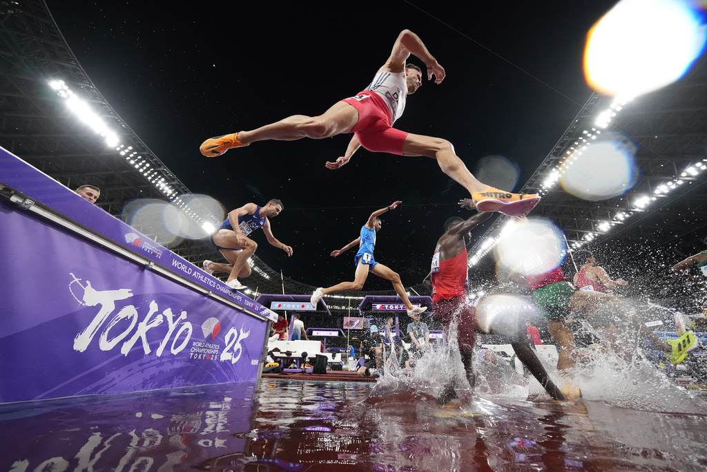 Athletes compete in a a men's 3,000 meters steeplechase heat at the World Athletics Championships in Tokyo, Saturday, Sept. 13, 2025. (AP Photo/Ashley Landis)