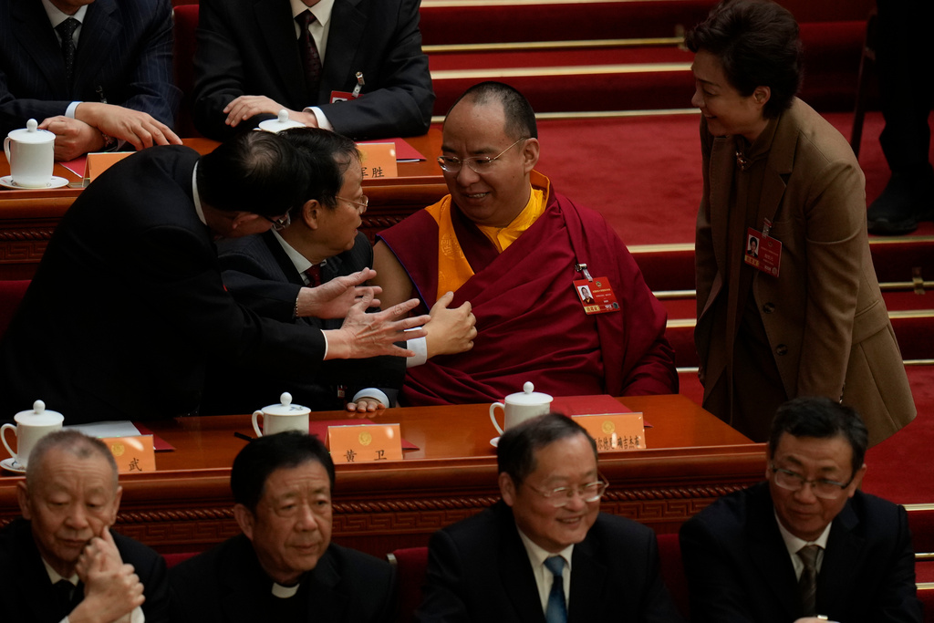 Delegates talk to Gyaltsen Norbu, the Chinese government-appointed 11th Panchen Lama during the closing ceremony of the Chinese People's Political Consultative Conference (CPPCC), in Beijing, Wednesday, March 11, 2026. (AP Photo/Ng Han Guan)