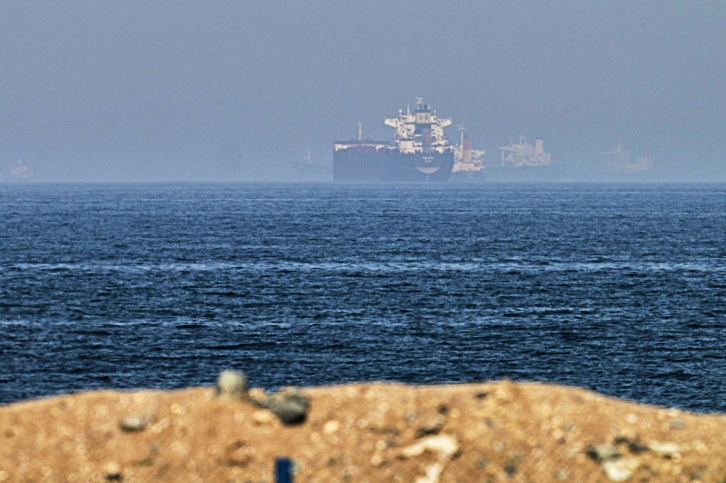 Cargo ships are seen at sea near the Strait of Hormuz, as viewed from a rocky shoreline near Khor Fakkan, United Arab Emirates, Friday, May 1, 2026. (AP Photo/Fatima Shbair)
