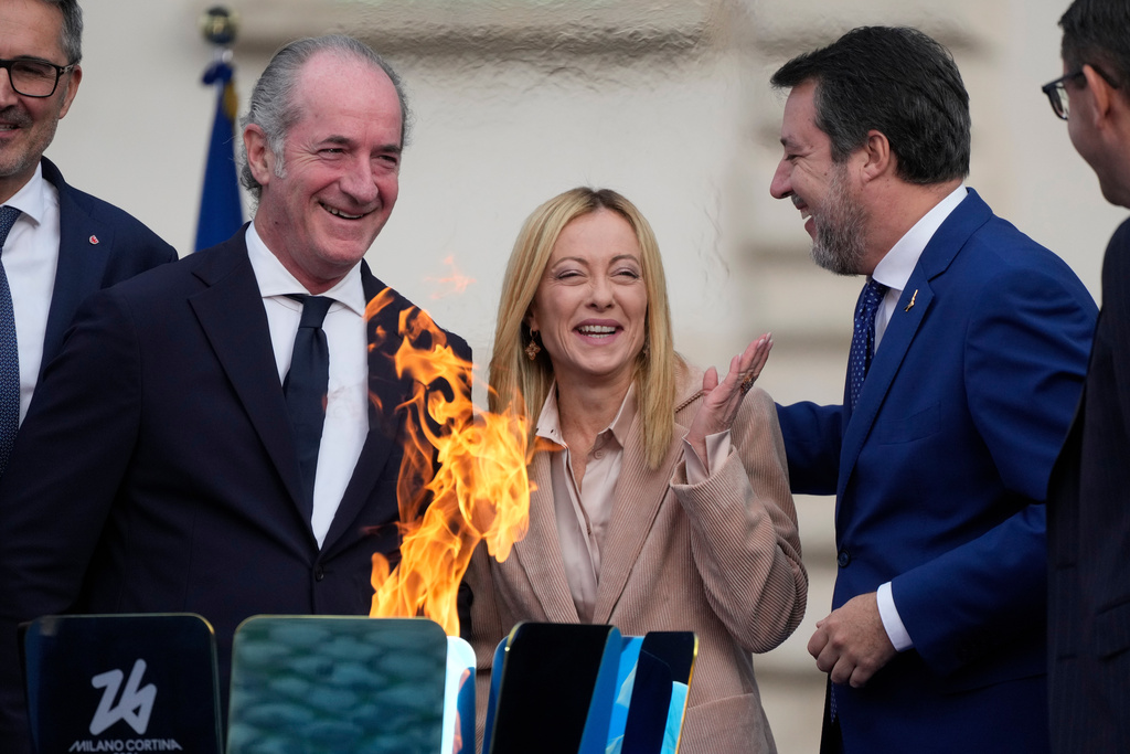 Italy's Prime Minister Giorgia Meloni, center is flanked by Veneto region President Luca Zaia, left, and vice president of Italy's Council of Ministers Matteo Salvini attend the Milan Cortina 2026 Winter Olympics cauldron lighting, in front of the Quirinale Presidential Palace, in Rome, Friday Dec. 5, 2025. (AP Photo/Gregorio Borgia)