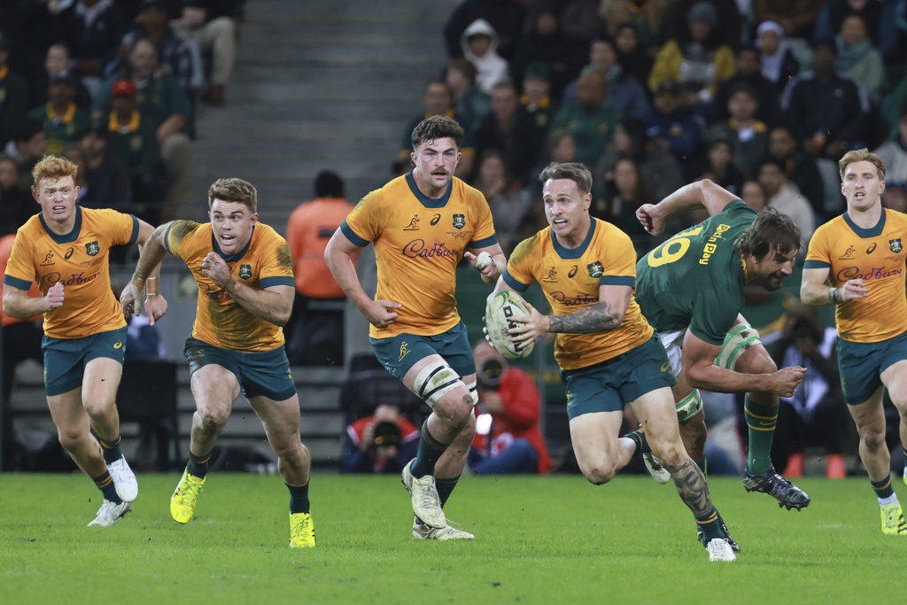 Australia's Corey Toole, front, breaks away from South Africa's Eben Etzebeth during a rugby championship test match between South Africa and Australia, at Cape Town stadium in Cape Town, South Africa, Saturday, Aug. 23, 2025. (AP Photo/Halden Krog)