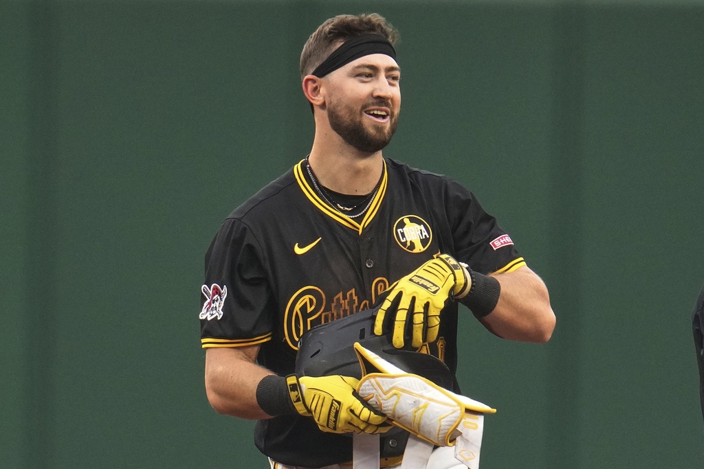 Pittsburgh Pirates' Jared Triolo stands on second base after hitting a double off Cincinnati Reds pitcher Brady Singer, driving in two runs, during the first inning of a baseball game in Pittsburgh, Thursday, Aug. 7, 2025. (AP Photo/Gene J. Puskar)