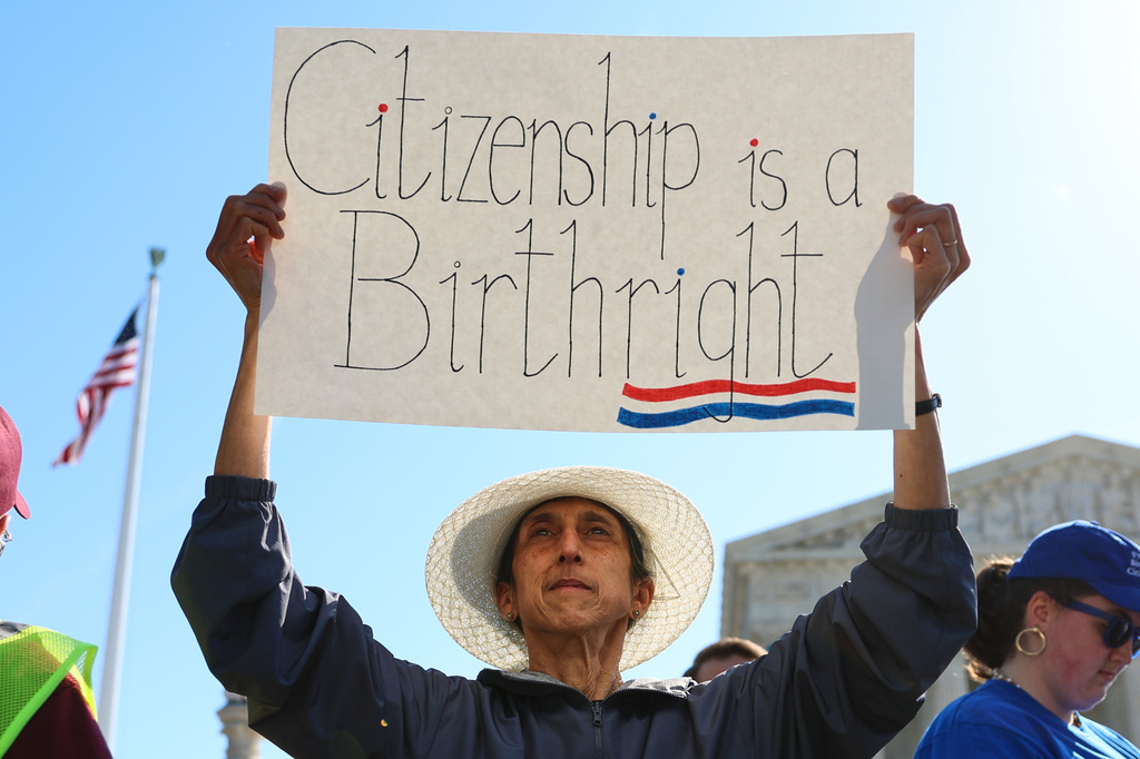 Demonstrators rally outside the U.S. Supreme Court as justices hear oral arguments on whether President Donald Trump can deny citizenship to children born to parents who are in the United States illegally or temporarily, on Capitol Hill in Washington, Wednesday, April 1, 2026. (AP Photo/Tom Brenner)