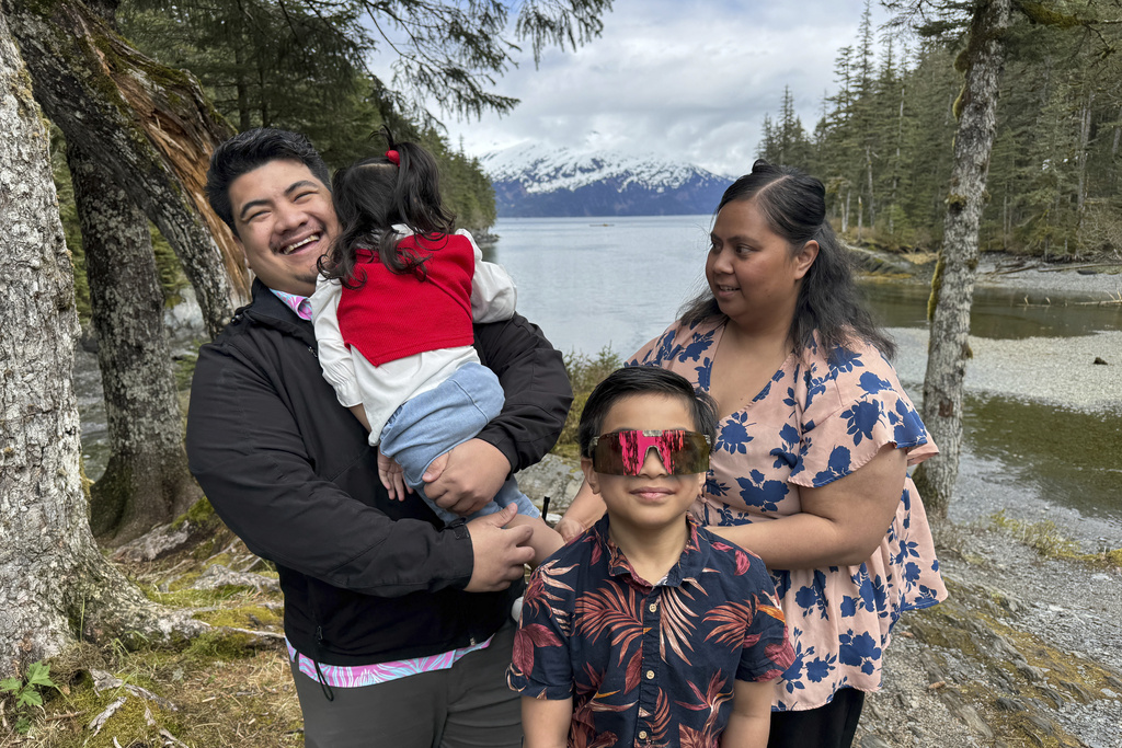 FILE - Michael Pese and his wife Tupe Smith pose for a photo with their son Maximus and daughter Cataleya in Whittier, Alaska, May 13, 2025. (AP Photo/Mark Thiessen, File)