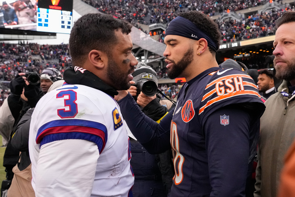New York Giants quarterback Russell Wilson (3) talks with Chicago Bears quarterback Caleb Williams (18) after an NFL football game Sunday, Nov. 9, 2025, in Chicago. (AP Photo/Nam Y. Huh)