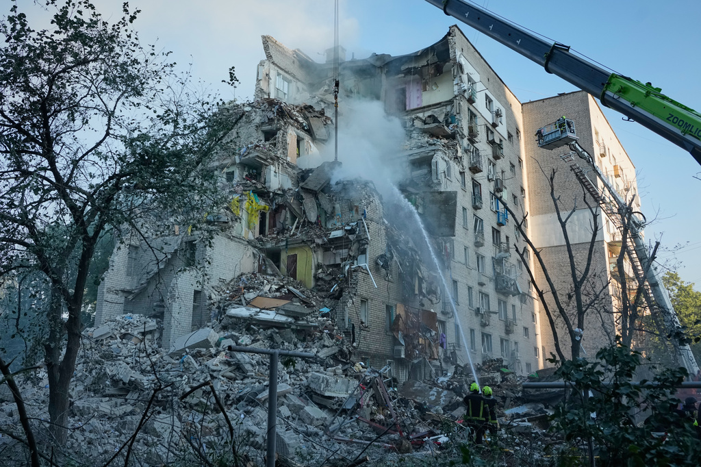 Emergency services personnel work to extinguish a fire after a Russian strike on Kyiv, Ukraine, Thursday, July 2, 2026. (AP Photo/Efrem Lukatsky)
