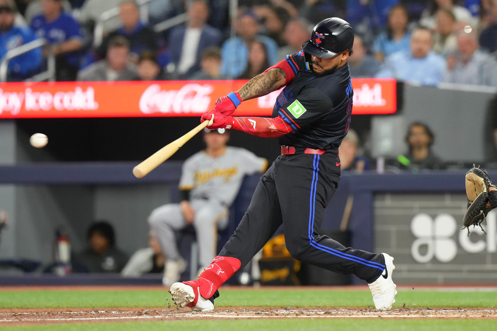 Toronto Blue Jays' Yohendrick Pinango (24) hits a two run RBI double off Pittsburgh Pirates pitcher Bubba Chandler during the third inning of a baseball game in Toronto, Friday, May 22, 2026. (Chris Young/The Canadian Press via AP)