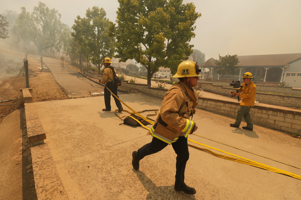 Fire crews battle the Sandy Fire Monday, May 18, 2026, in Simi Valley, Calif. (AP Photo/Ethan Swope)