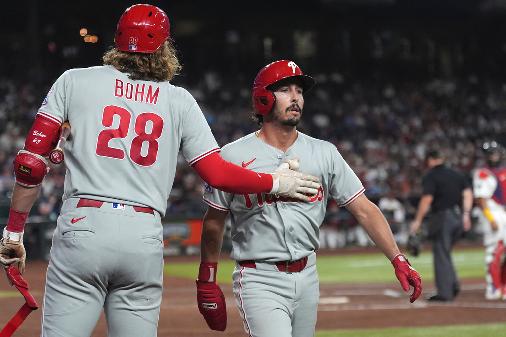 Philadelphia Phillies' Garrett Stubbs, right, is congratuated by Phillies' Alec Bohm (28) after Stubbs scored a run against the Arizona Diamondbacks during the third inning of a baseball game, Monday, Aug. 31, 2026, in Phoenix. (AP Photo/Ross D. Franklin)