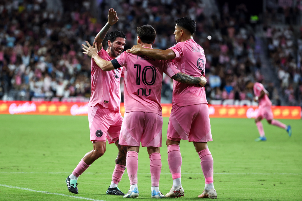 Inter Miami forward Lionel Messi (10) celebrates with midfielder Rodrigo De Paul, left, and forward Luis Suárez (9) after scoring on a free kick during the first half of an MLS soccer game against San Diego FC, Sunday, Sept. 20, 2026, in Miami. (AP Photo/David Santiago)
