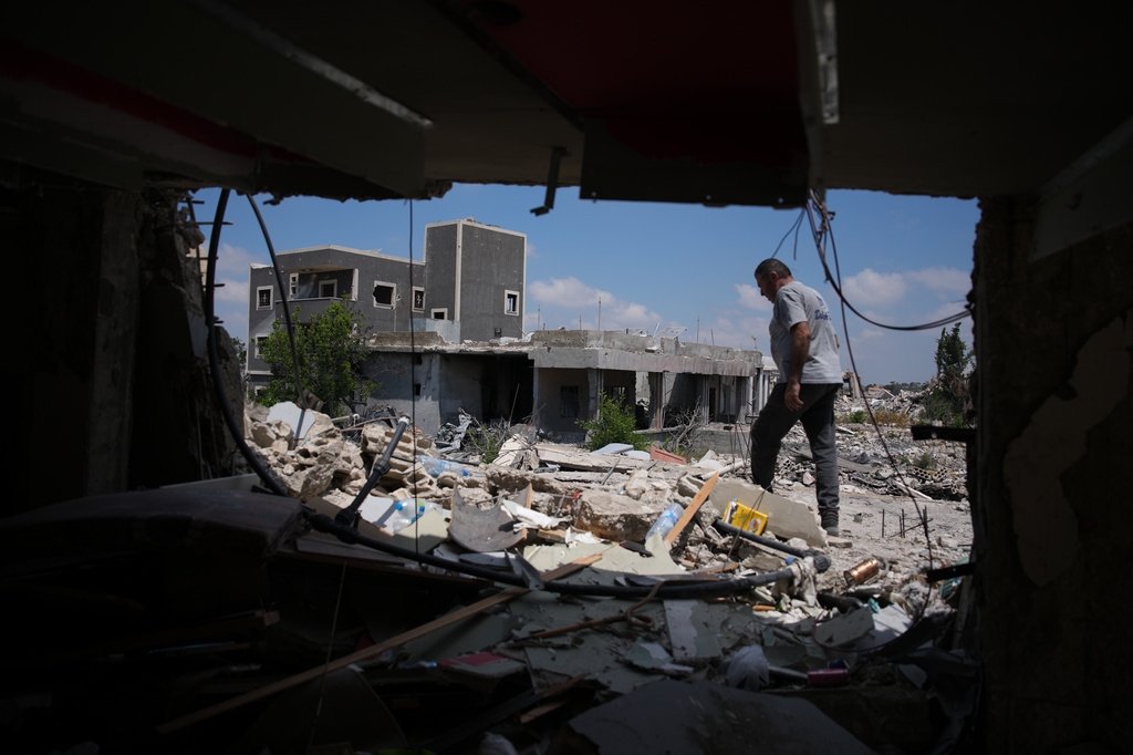 A resident inspects the damage to his home, destroyed in an Israeli airstrike during the Israel-Hezbollah war in Ghandouriyeh village, southern Lebanon, Tuesday, July 21, 2026. (AP Photo/Hassan Ammar)