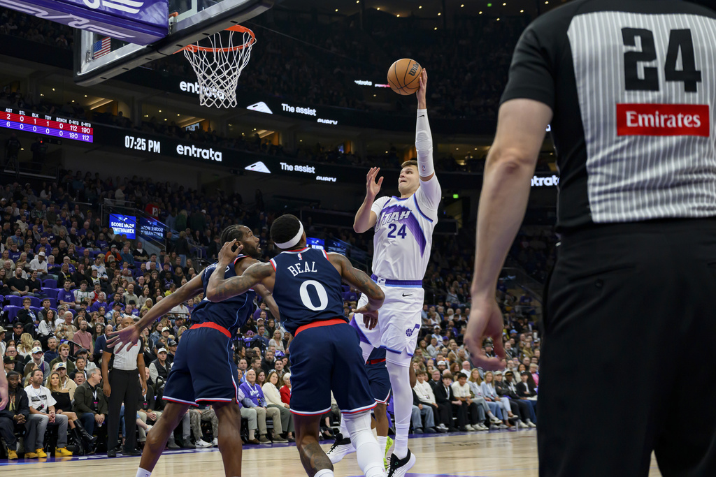 Utah Jazz center Walker Kessler, second from righ, shoots while defended by Los Angeles Clippers guard Bradley Beal (0) and forward Kawhi Leonard, left, during the first half of an NBA basketball game, Wednesday, Oct. 22, 2025, in Salt Lake City. (AP Photo/Tyler Tate)
