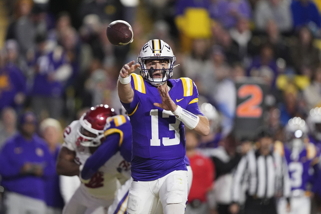 FILE - LSU quarterback Garrett Nussmeier (13) throws a pass in the first half an NCAA college football game against Oklahoma in Baton Rouge, La., Nov. 30, 2024. (AP Photo/Gerald Herbert, File)