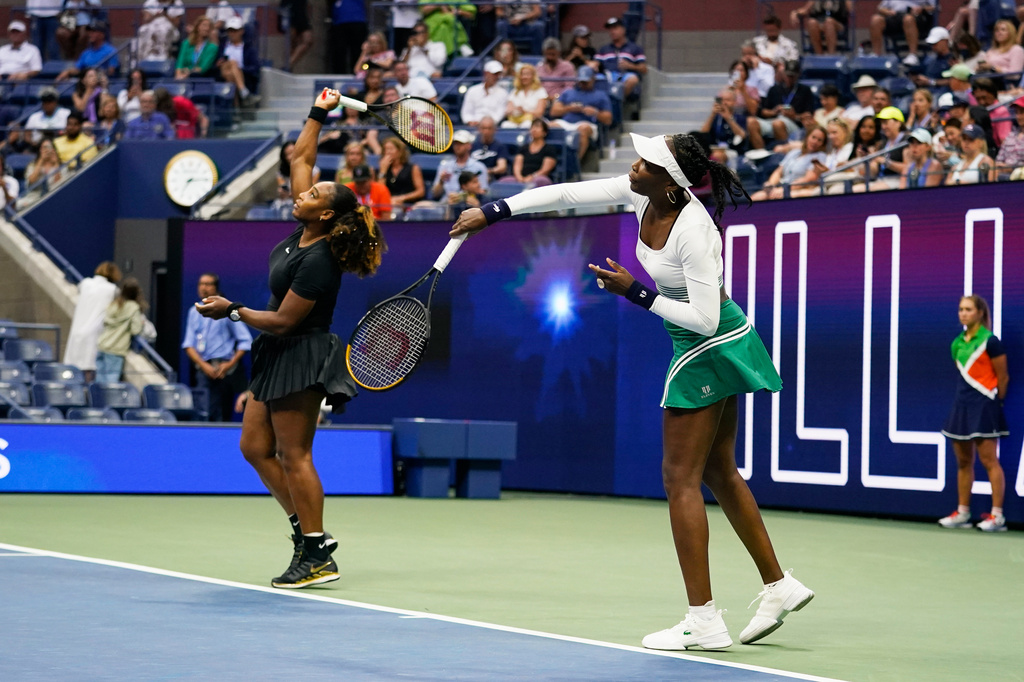 FILE - Serena Williams, left, and Venus Williams, of the United States, warm up before their first-round doubles match against Lucie Hradecká and Linda Nosková, of the Czech Republic, at the U.S. Open tennis championships, Sept. 1, 2022, in New York. (AP Photo/Charles Krupa, File)