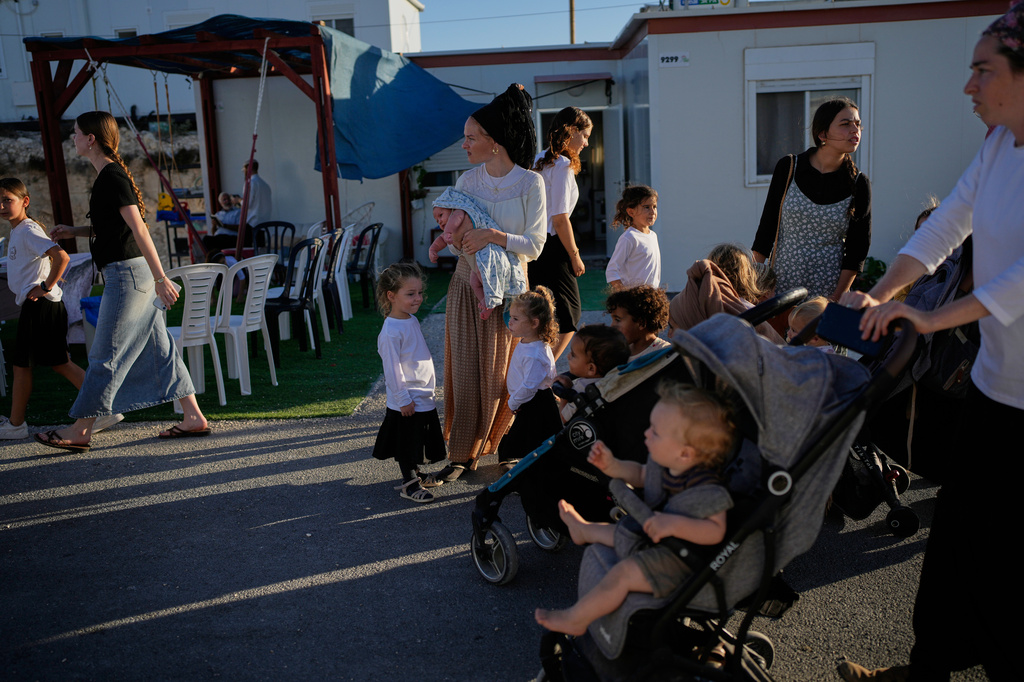 Israeli settlers gather to celebrate the inauguration of a newly built synagogue at the occupied West Bank outpost of Homesh, Wednesday, Sept. 16, 2026. (AP Photo/Ohad Zwigenberg)