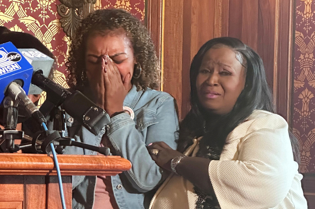 Veronica Ruiz, the sister of Corey Ruiz, who was killed by Madison police, breaks down in tears and is comforted by Wisconsin state Rep. Shelia Stubbs, D-Madison, right, Friday, July 24, 2026, in Madison, Wis. (AP Photo/Scott Bauer)