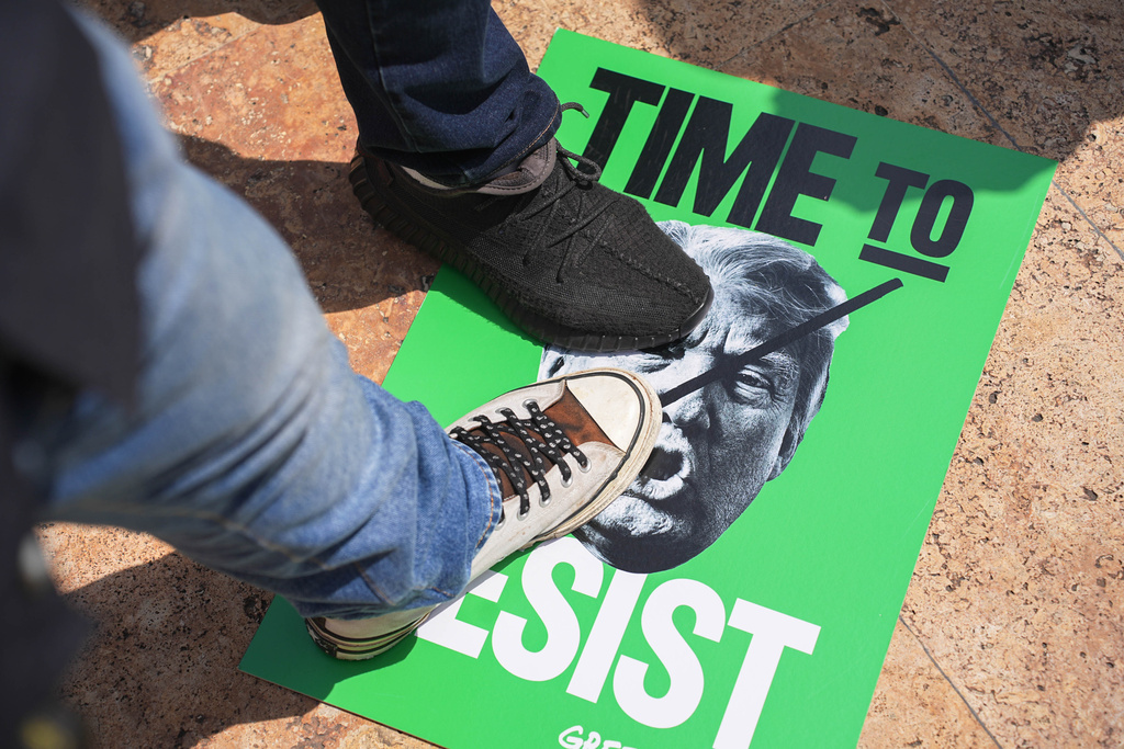 Protesters steps on a poster of U.S. President Donald Trump during a demonstration his attendance at the Association of Southeast Asian Nations (ASEAN) Summit in Kuala Lumpur, Malaysia, on Sunday, Oct. 26, 2025. (AP Photo/Azneal Ishak)