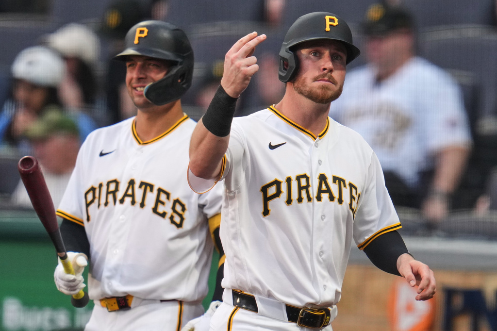 Pittsburgh Pirates' Ryan O'Hearn, right, returns to the dugout after celebrating with Nick Yorke after scoring on a single by Nick Gonzales off Washington Nationals pitcher Jake Irvin during the first inning of a baseball game in Pittsburgh, Wednesday, April 15, 2026. (AP Photo/Gene J. Puskar)