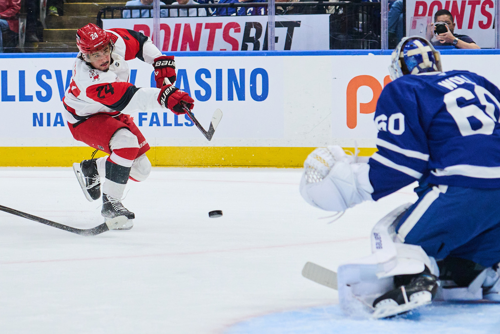 Carolina Hurricanes' Seth Jarvis (24) shoots against Toronto Maple Leafs goaltender Joseph Woll (60) during first-period NHL hockey game action in Toronto, Friday, March 20, 2026. (Sammy Kogan/The Canadian Press via AP)